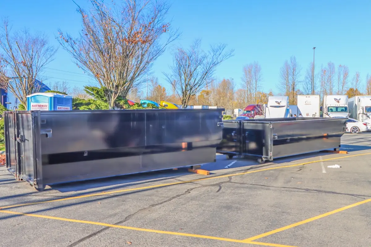 Professional dumpster rental service with roll-off container on residential driveway in Litchfield